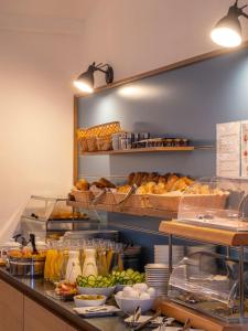 a kitchen with a counter with bread and other food at Villa Flöckner Bed & Breakfast in Salzburg