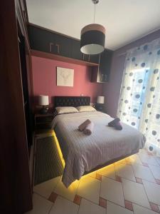 a bedroom with a bed with two towels on it at Happy Colors House Xanthi in Xanthi