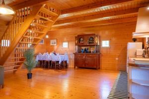 a dining room with a table in a wooden house at Chalet Guapa in Bohinj