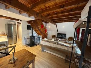 a large living room with a couch and a table at Les Vaillants Chalet - Vielle Aure in Vielle-Aure