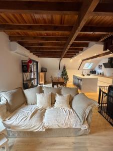 a living room with a large couch in a room at Les Vaillants Chalet - Vielle Aure in Vielle-Aure