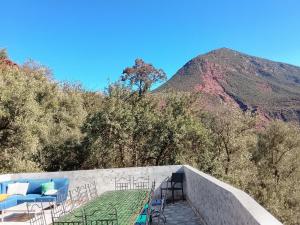 a stairway with chairs and a mountain in the background at Chez Yahia, Au coeur de L'Ourika in Ourika