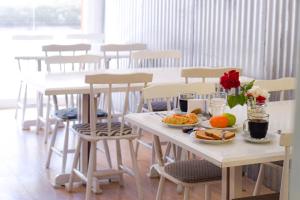 a table with plates of food and flowers on it at Hotel Parque in Necochea