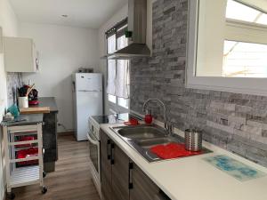 a kitchen with a sink and a refrigerator at Marieno in Barbâtre