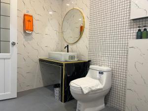 a bathroom with a toilet and a sink and a mirror at เพาะสุข กู๊ดดรีม in Ban Wang Hu Kwang
