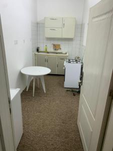 a small kitchen with a white table and a table at Danzha Royal 4 in Erbil