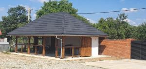 a gazebo with a black roof at Casa Teodor in Mărgineni