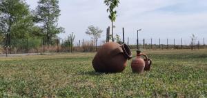 a sculpture of an elephant sitting in a field at Casa Teodor in Mărgineni