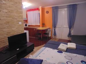 a bedroom with two beds and a kitchen with a table at Nocleg u Mario in Uniejow +1 photo