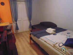a small bedroom with a bed and a door at Nocleg u Mario in Uniejow