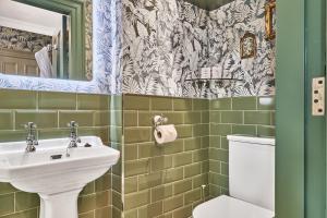 a bathroom with a sink and a toilet at The Lawrence in Derry Londonderry +104 photos