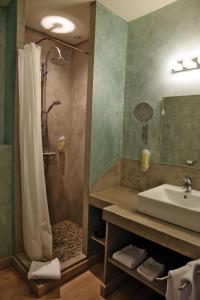 a bathroom with a shower and a sink at Des Lits Sur La Place in Hérépian +83 photos