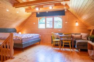 a bedroom with a bed and a table and chairs at Chalet Guapa in Bohinj