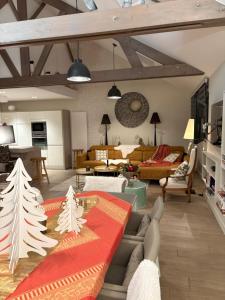 a living room with a table with christmas trees on it at Villa Le Rubis in Agon-Coutainville