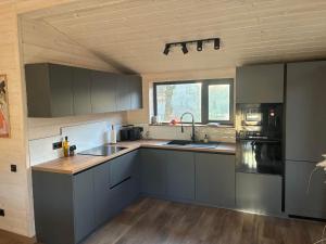 a kitchen with gray cabinets and a counter top at Ferienhaus Barth in Waldbröl in Waldbröl +2 photos