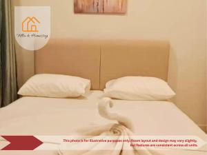 two beds with white sheets and pillows in a room at ImpianKU MetaStay KL in Seri Kembangan +17 photos