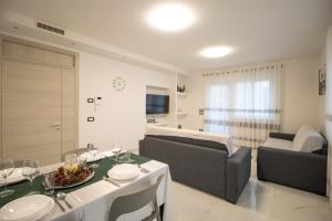 a living room with a table and a couch at Loft Giuliana in San Michele allʼAdige