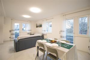 a living room with a table and a couch at Loft Giuliana in San Michele allʼAdige
