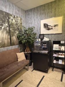 a waiting room with a couch and a table at Hotel Centrum Business in Krakow
