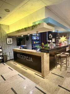 a restaurant with a reception counter and a bar at Hotel Centrum Business in Krakow +35 photos
