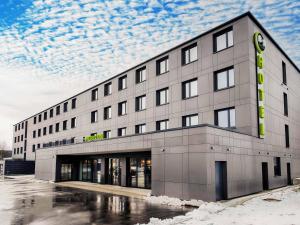 a large building with a sign on the side of it at B&B Hotel Augsburg-West in Augsburg