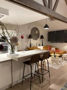 a kitchen and living room with a table and chairs at Villa Le Rubis in Agon-Coutainville
