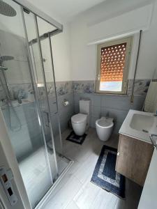 a bathroom with a shower and a toilet and a sink at Casa Nonna Etna in Linguaglossa