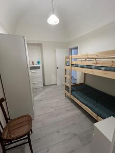 a room with two bunk beds and a chair at Casa Nonna Etna in Linguaglossa