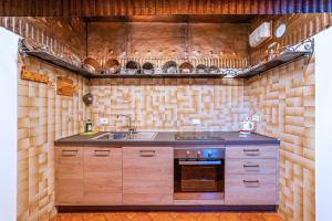 a kitchen with a sink and a stove at Tizzi Home in Alleghe
