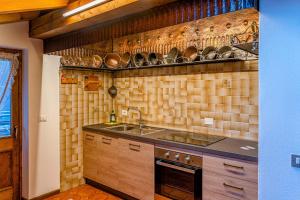 a kitchen with a sink and a counter top at Tizzi Home in Alleghe +17 photos