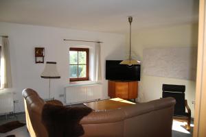 a living room with a couch and a table at Ferienwohnung am Stadtrand in Dresden