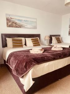 a bedroom with a large bed with towels on it at The Haven in Holyhead