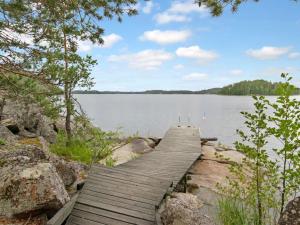 a wooden bridge over a large body of water at Holiday Home Ulappa by Interhome in Hurissalo