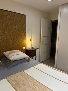 a bedroom with a large bed and a desk at Villa Le Rubis in Agon-Coutainville