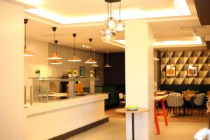 a restaurant with pendant lights and a dining room at Holiday Inn Basingstoke by IHG in Basingstoke