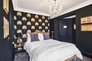 a bedroom with a large bed and a chandelier at The Lawrence in Derry Londonderry