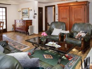a living room with two leather chairs and a coffee table at Chalet Chalet Chante Neige by Interhome in Riddes