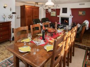 a dining room with a wooden table and chairs at Chalet Chalet Chante Neige by Interhome in Riddes