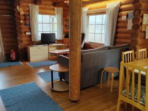 a living room with a couch and a table at Holiday Home Heinäsorsa by Interhome in Rutalahti