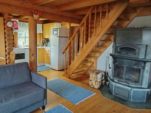 a living room with a couch and a stove at Holiday Home Heinäsorsa by Interhome in Rutalahti +27 photos