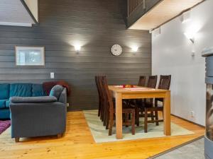 a living room with a table and a couch at Holiday Home Pulkka 2 by Interhome in Salla