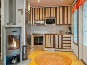 a kitchen with a fireplace in the middle of it at Holiday Home Pulkka 2 by Interhome in Salla