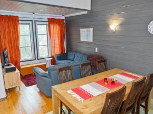 a living room with a table and a couch at Holiday Home Pulkka 2 by Interhome in Salla