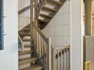 a winding staircase in a building with wooden treads at Holiday Home Pulkka 2 by Interhome in Salla +14 photos