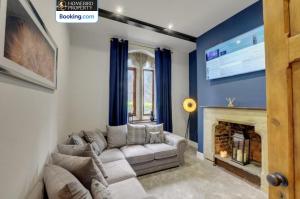 a living room with a couch and a fireplace at Large 6BDR House By Homebird Property Management Short Lets & Serviced Accommodation Leeds With Secured Parking & Garden Area in Leeds