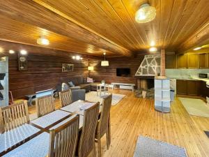 a dining room with tables and chairs and a fireplace at Holiday Home Metsäpirtti by Interhome in Vaskivesi