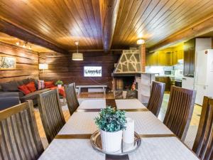 a dining room with a table and a couch at Holiday Home Metsäpirtti by Interhome in Vaskivesi
