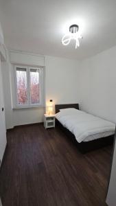 a bedroom with a large bed and a window at Casa Giovanni in Turin