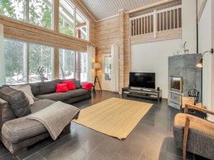 a living room with a couch and a flat screen tv at Holiday Home Villa utu by Interhome in Kolinkylä