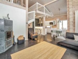 a living room with a fireplace and a dining room at Holiday Home Villa utu by Interhome in Kolinkylä